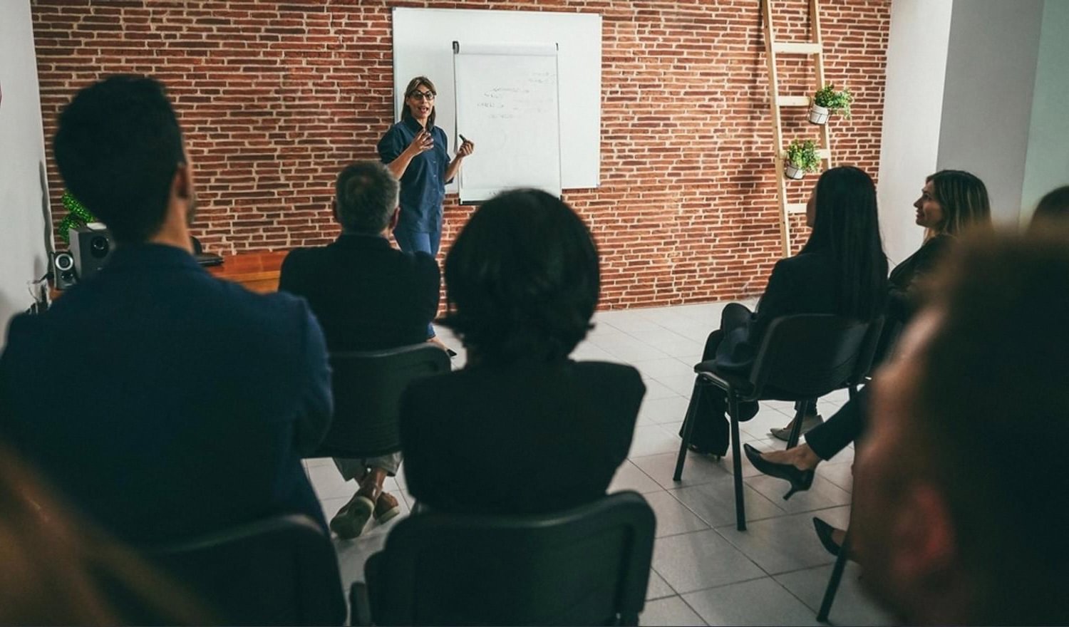 Instructor teaching a face-to-face class to adult students in a UAE training room